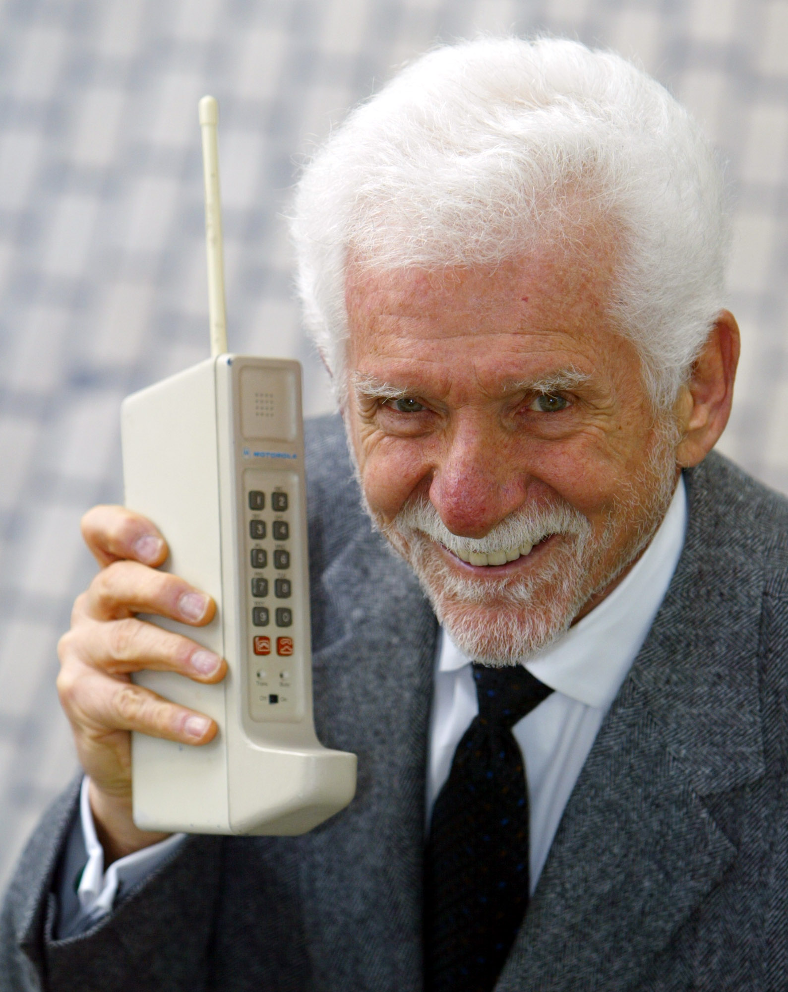Martin Cooper holds a Motorola DynaTAC